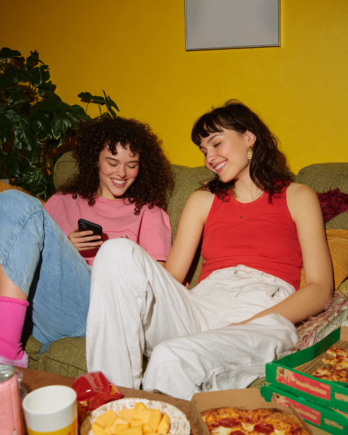Friends enjoying humorous content on a screen, reflecting the shared joy that funny characters bring to an audience.