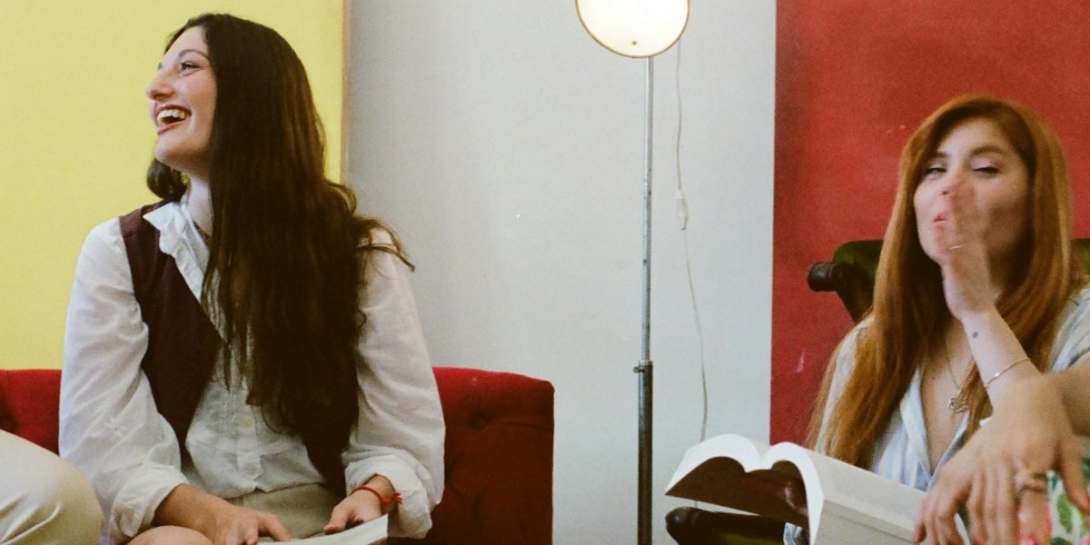 A person enjoying a humorous story, reflecting the article's invitation to explore comedic craft.