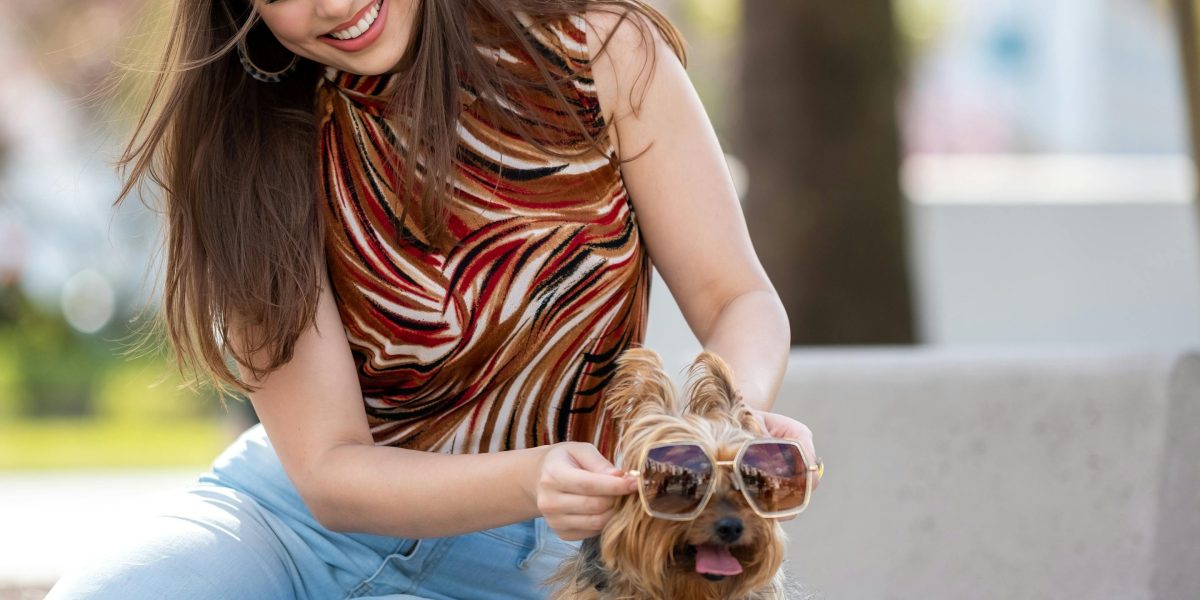 A person sharing a joyful moment and laughter with their dog.