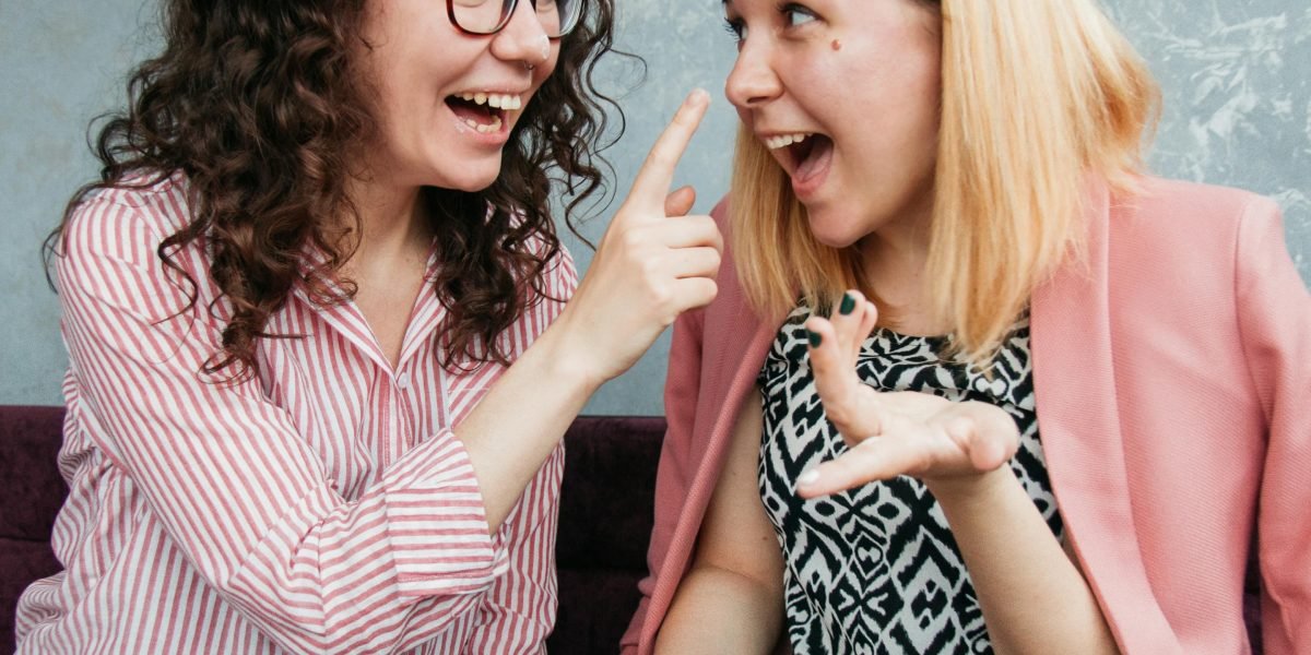 Friends enjoying a moment of shared laughter, reflecting the universal human experience of humour.