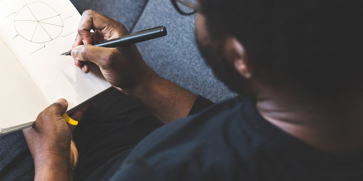 A person intently brainstorming, reflecting the creative process of naming characters in a novel.