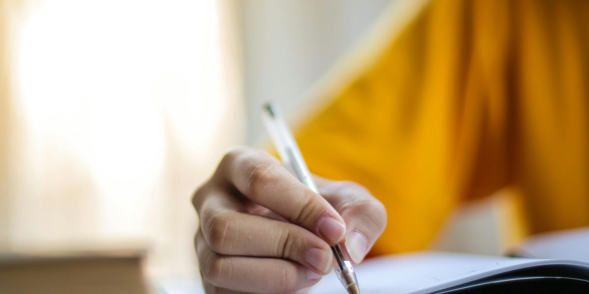 A person immersed in creative writing, imagining a unique character's perspective.