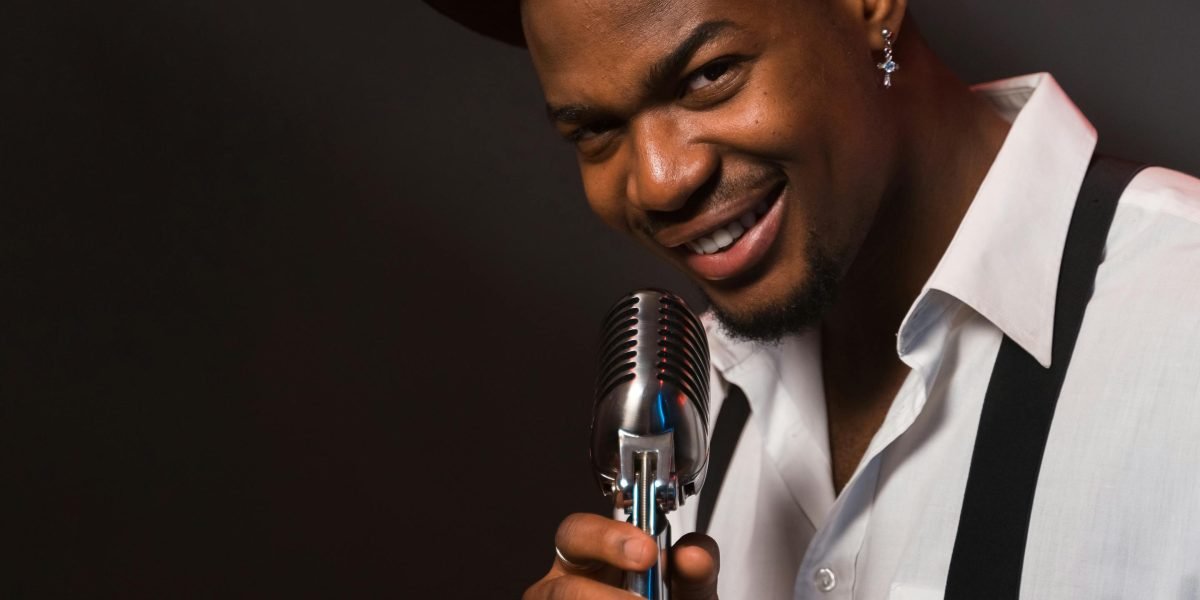 A comedian on stage delivering a performance, representing the art of comedic timing and delivery.