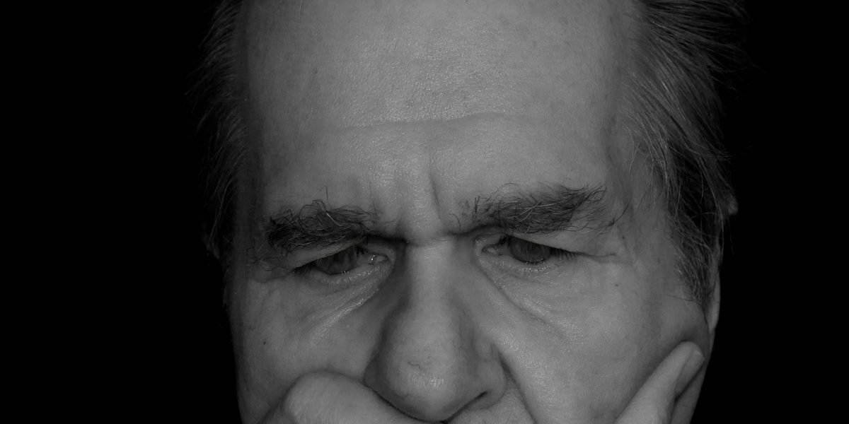 A person with a pensive expression, representing the thoughtful consideration of ethical issues in online content.
